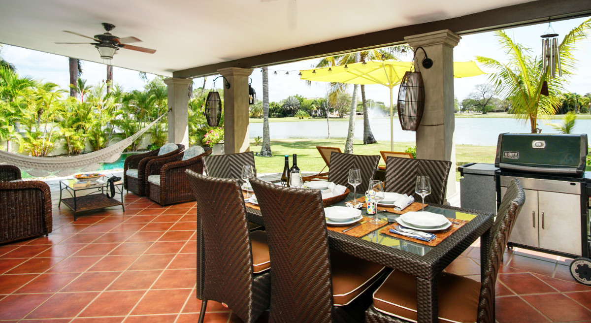 Outdoor dining terrace with lake views at a short-term rental villa in Panama